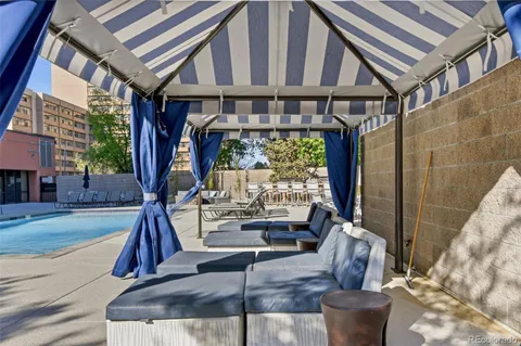 a view of a patio with couches table and chairs and potted plants