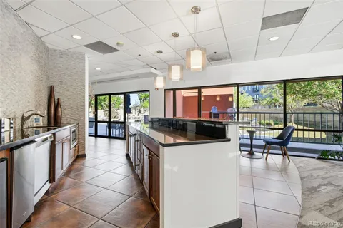 a living room with furniture a fireplace and a floor to ceiling window