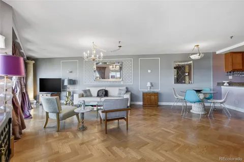 a living room with furniture and a chandelier
