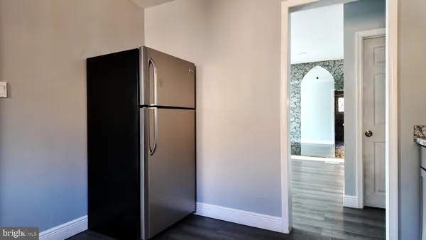 a view of bathroom with wooden floor washer and dryer