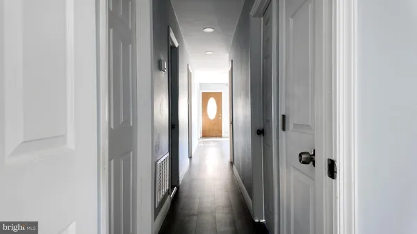 a view of a hallway with wooden floor