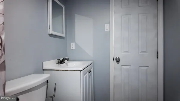 a bathroom with a sink toilet and a mirror