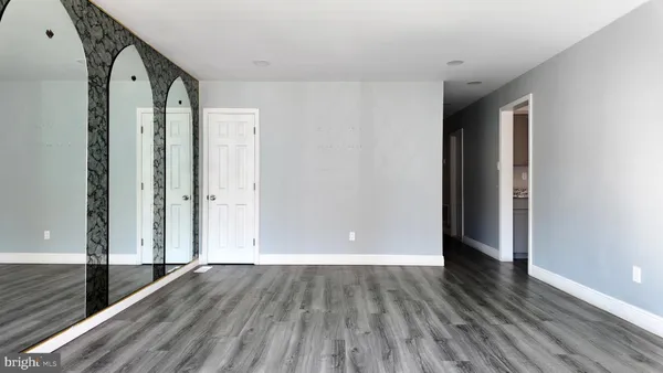 a view of hallway with wooden floor