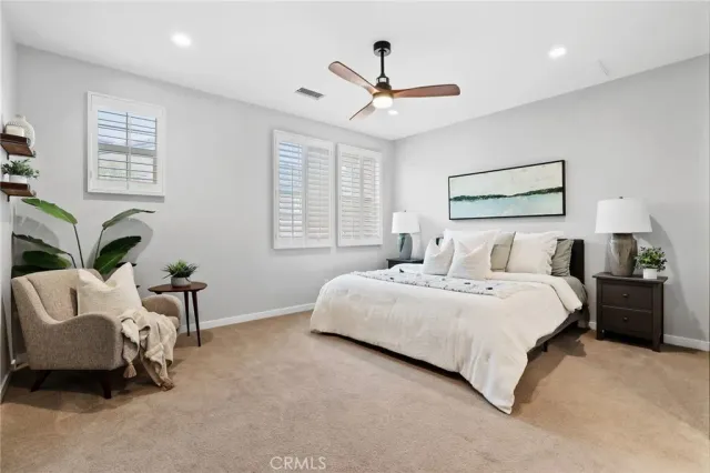 a bedroom with furniture and a large window