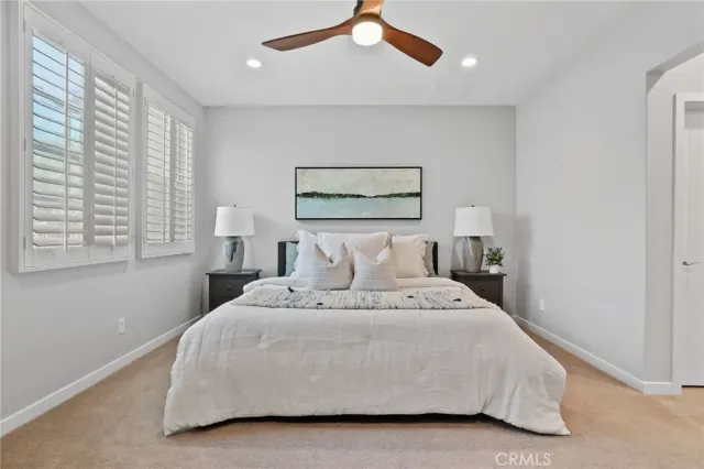 a bedroom with furniture and a large window