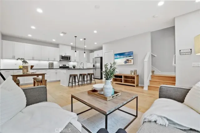 a living room with furniture and kitchen view