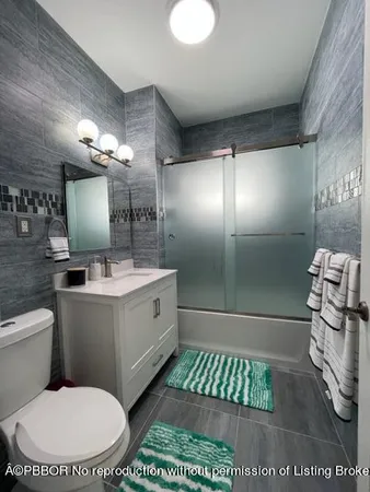 a bathroom with a double vanity sink mirror and toilet