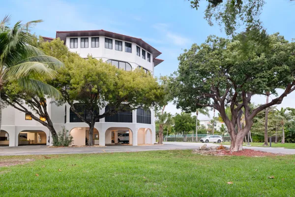 an aerial view of a building with garden space and outdoor seating