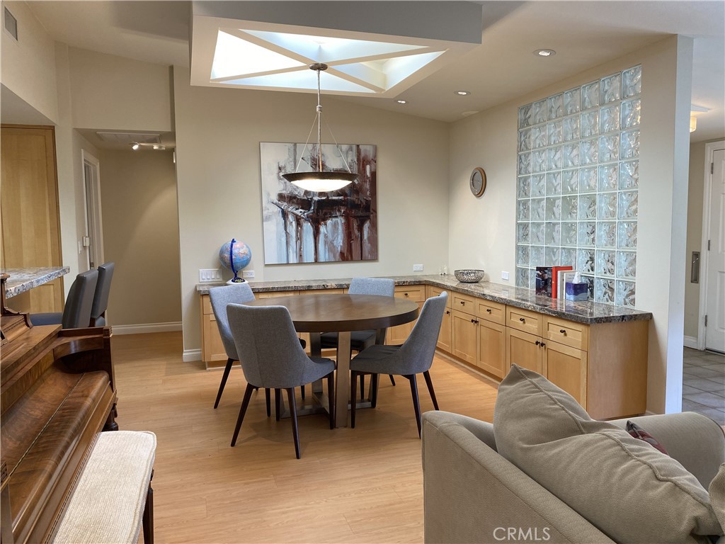 1771 Sunningdale Road Seal Beach, CA 90740 - Photo 16 of 30 a living room with furniture a dining table and a fireplace
