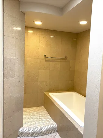 a bathroom with a tub and a shower