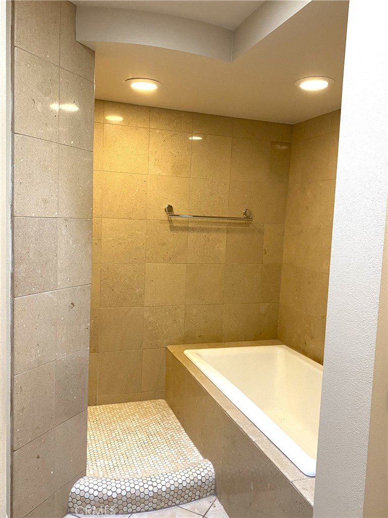 1771 Sunningdale Road Seal Beach, CA 90740 - Photo 18 of 30 a bathroom with a tub and a shower
