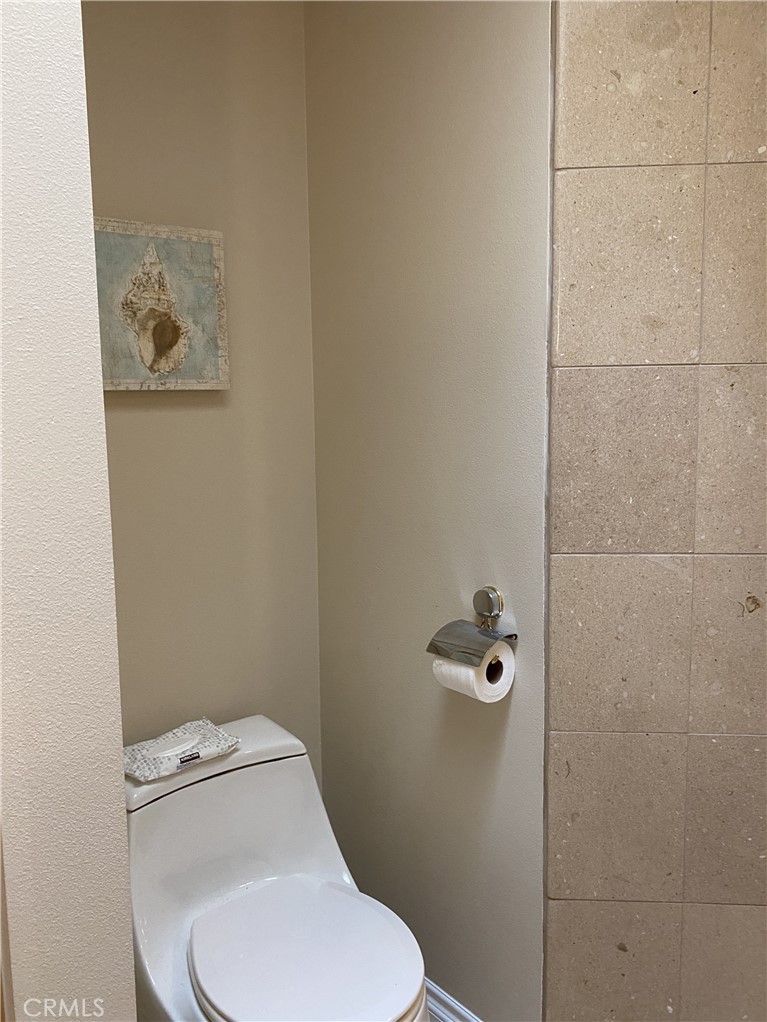 1771 Sunningdale Road Seal Beach, CA 90740 - Photo 19 of 30 a white toilet sitting next to a bathroom sink