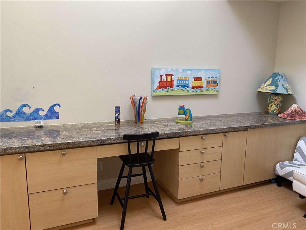 1771 Sunningdale Road Seal Beach, CA 90740 - Photo 23 of 30 a dining hall with cabinets and a wooden floor