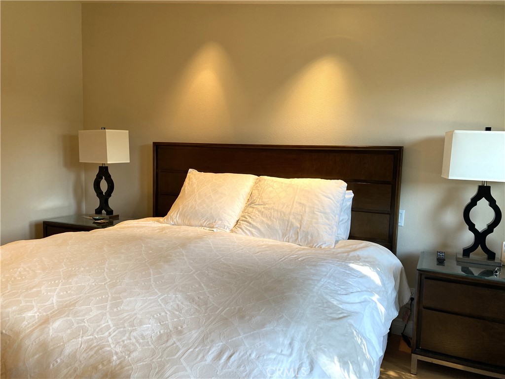 1771 Sunningdale Road Seal Beach, CA 90740 - Photo 25 of 30 a large bed sitting in a bedroom and lamp