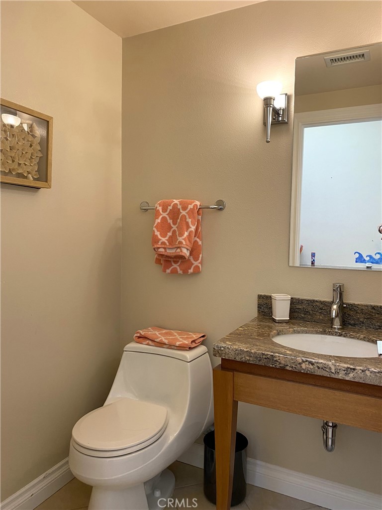 1771 Sunningdale Road Seal Beach, CA 90740 - Photo 30 of 30 a bathroom with a granite countertop toilet sink and mirror