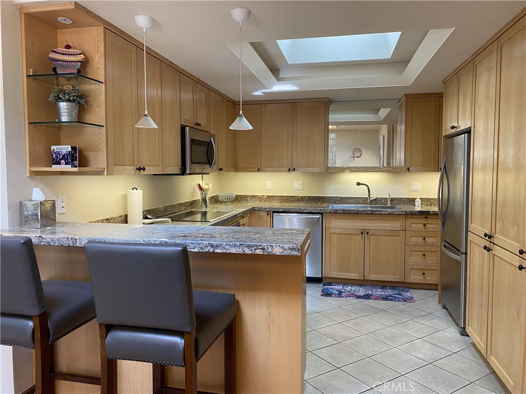 1771 Sunningdale Road Seal Beach, CA 90740 - Photo 6 of 30 a kitchen with a sink refrigerator and cabinets
