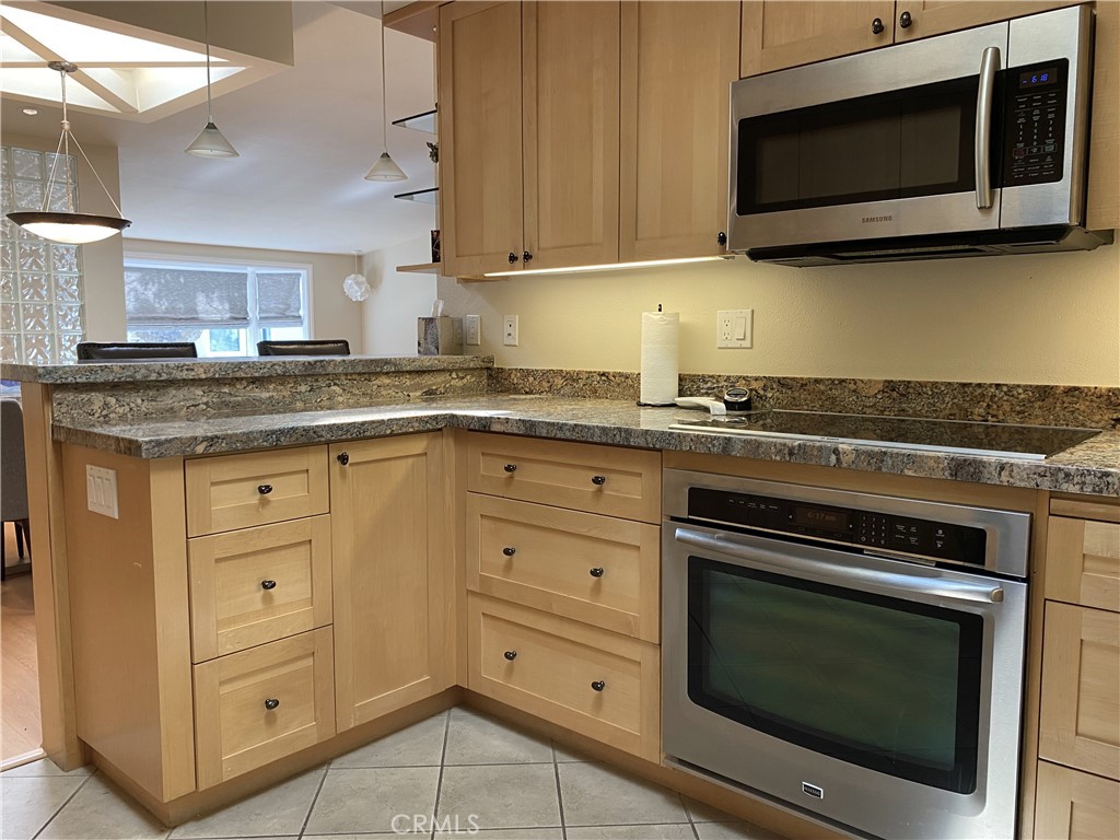 1771 Sunningdale Road Seal Beach, CA 90740 - Photo 7 of 30 a kitchen with granite countertop a stove microwave and sink