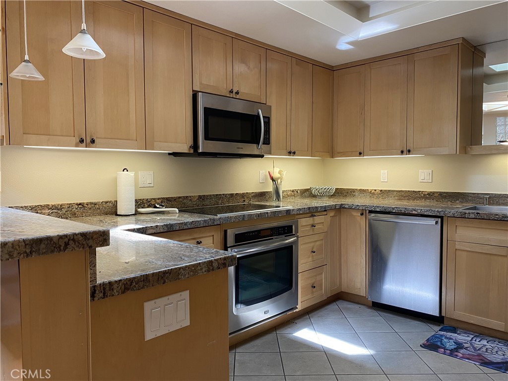 1771 Sunningdale Road Seal Beach, CA 90740 - Photo 8 of 30 a kitchen with stainless steel appliances granite countertop a stove a sink and a microwave