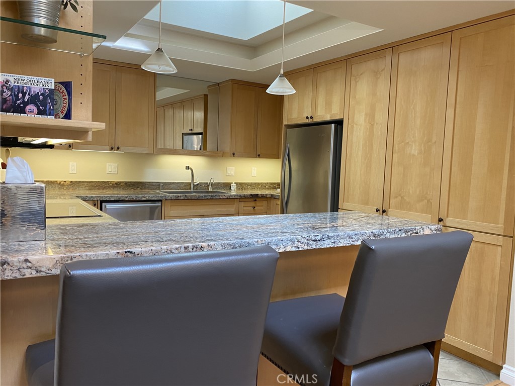 1771 Sunningdale Road Seal Beach, CA 90740 - Photo 10 of 30 a kitchen with granite countertop a sink cabinets and stainless steel appliances