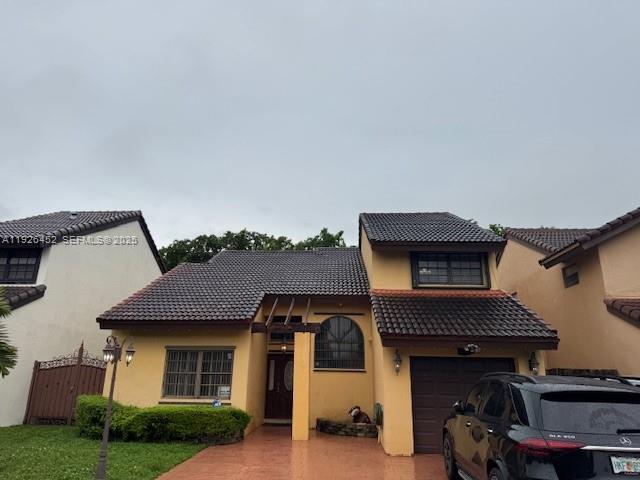 6311 Southwest 127th Court, Unit 6311 Miami, FL 33183 - Photo 1 of 13 a front view of a house with garden