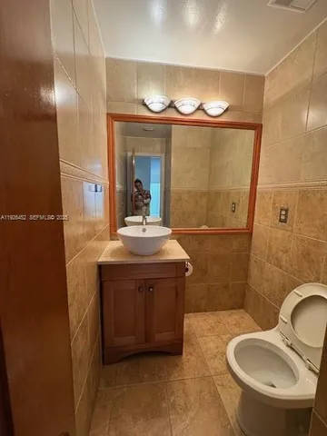 a bathroom with a sink a mirror a toilet and a shower