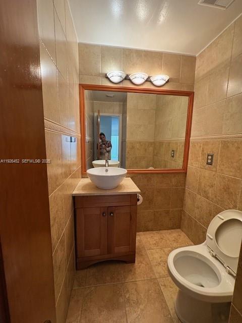 6311 Southwest 127th Court, Unit 6311 Miami, FL 33183 - Photo 6 of 13 a bathroom with a sink a mirror a toilet and a shower
