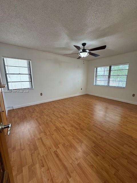 6311 Southwest 127th Court, Unit 6311 Miami, FL 33183 - Photo 7 of 13 wooden floor in an empty room with a window
