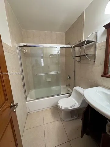a bathroom with a sink a toilet and a shower