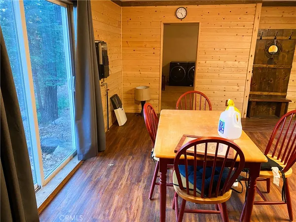 a view of a door and chair in wooden floor