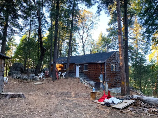 a view of a patio with table and chairs under an umbrella