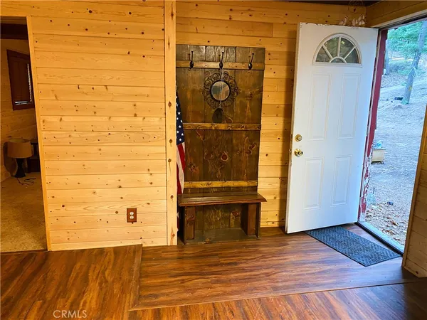 a kitchen with stainless steel appliances kitchen island granite countertop a table chairs in it and wooden floors