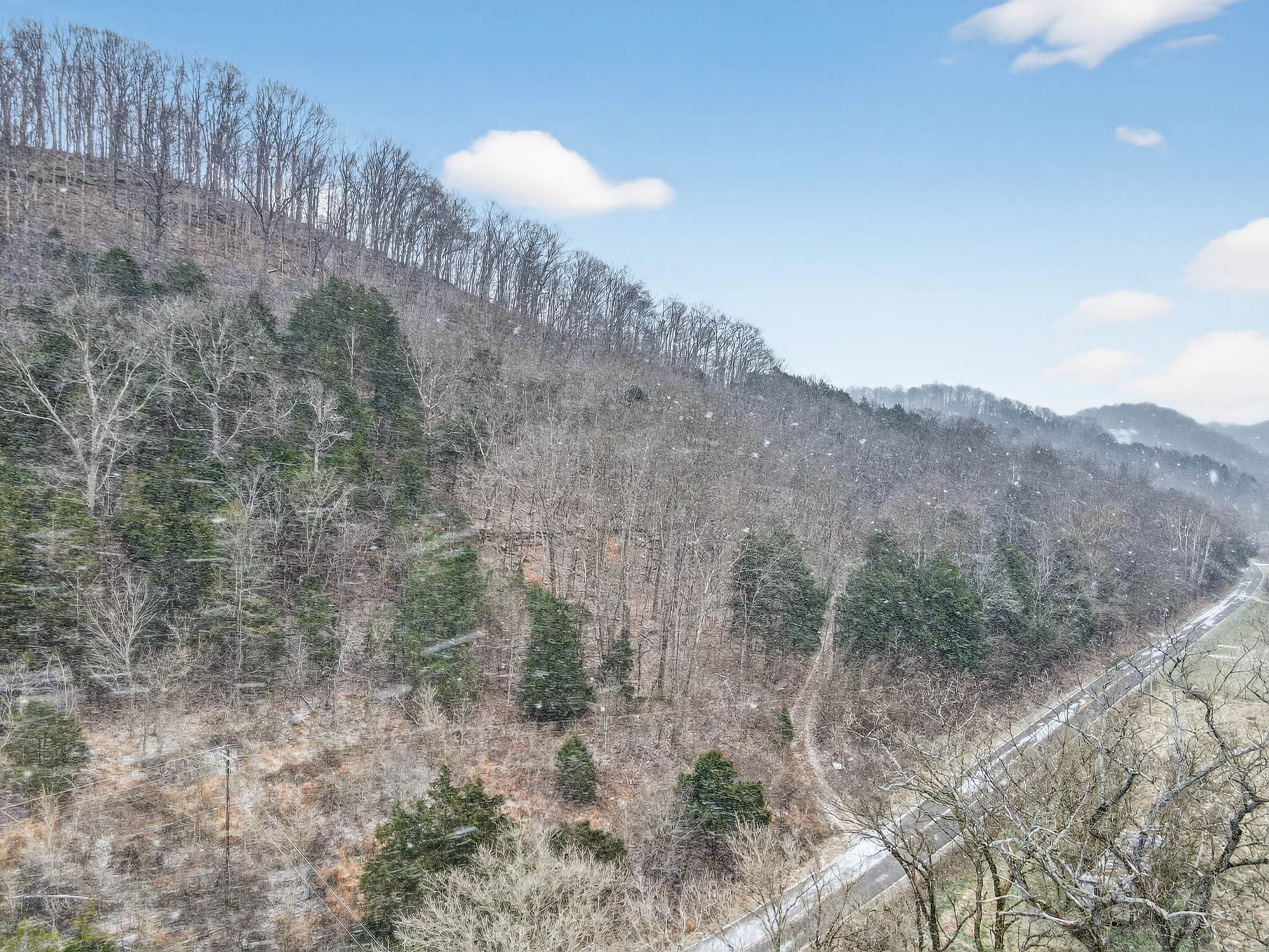 a view of a dry yard with mountains in the background