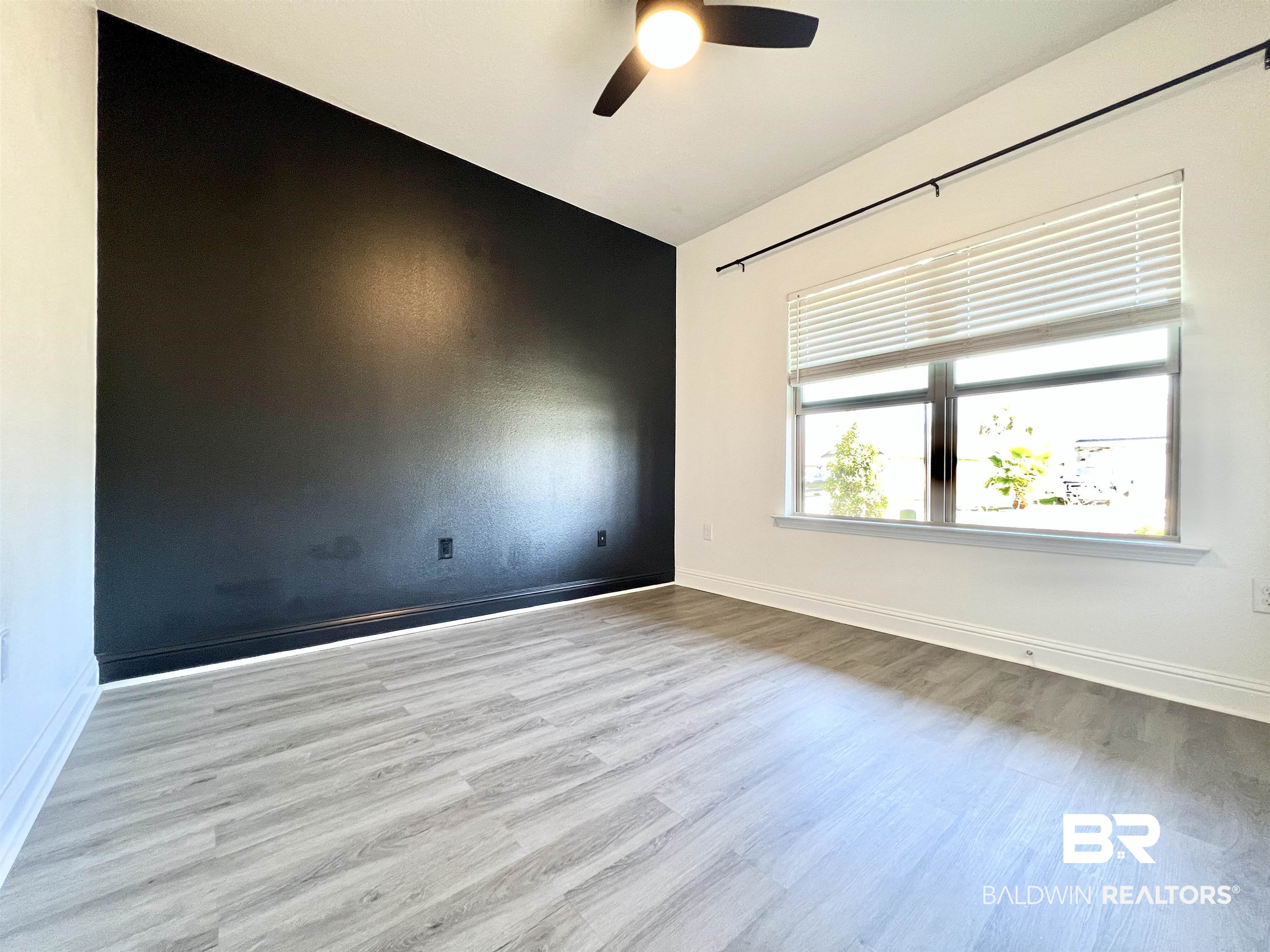 24785 Slater Mill Road Daphne, AL 36526 - Photo 18 of 46 Empty room with light hardwood / wood-style floors, lofted ceiling, and ceiling fan