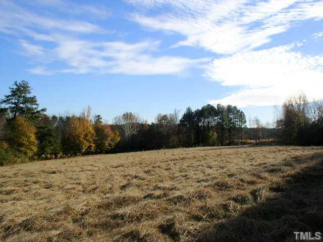 4425 Green Level W Road, Unit 1 Apex, NC 27523 - Photo 2 of 3 Partial view of uper field on south side of Green Level West Road. Property extends well beyond the tree line.