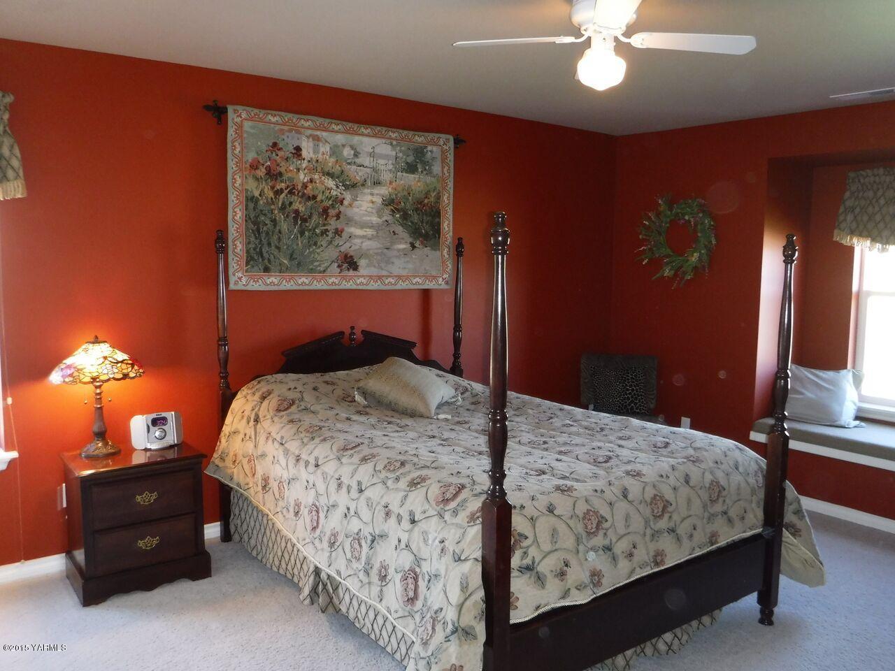 11301 Summitview Ext Road Yakima, WA 98908 - Photo 35 of 45 a bedroom with a bed and a lamp on dresser