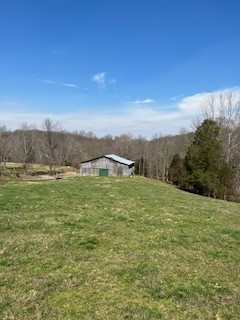 403 Woodard Road Lafayette, TN 37083 - Photo 1 of 21 a view of a big yard with an trees