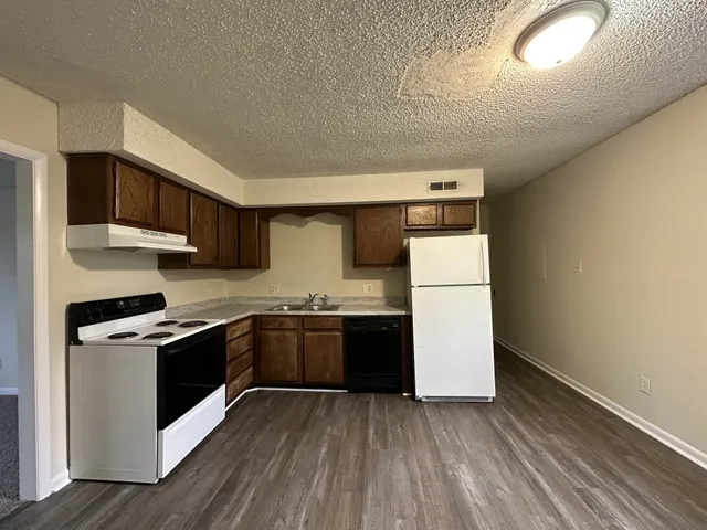 a kitchen with stainless steel appliances granite countertop a stove a refrigerator and a microwave