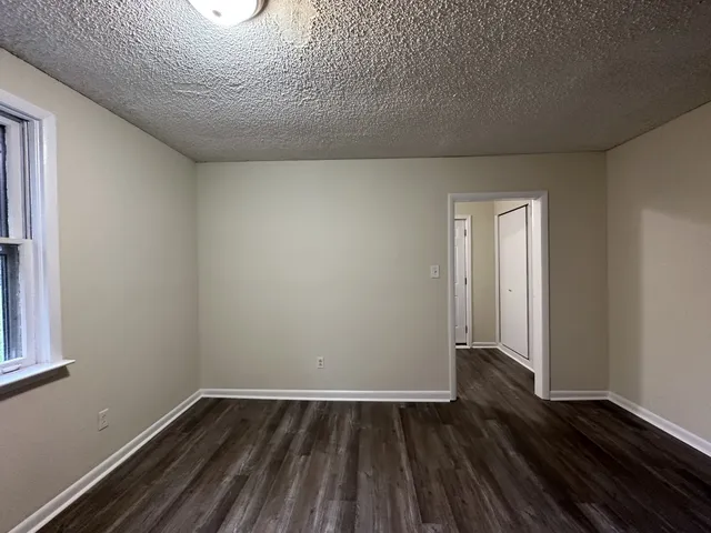 a view of an empty room and wooden floor