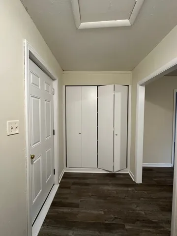 a view of a hallway with wooden floor