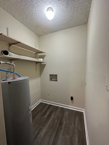 a view of a room with wooden floor