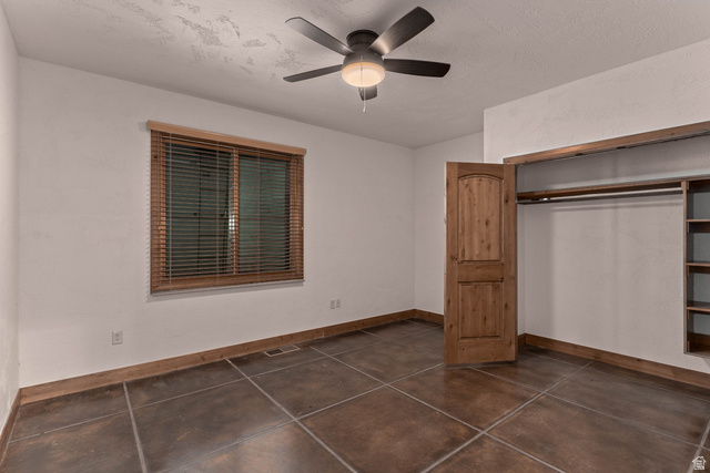 2464 East Granite Way St. George, UT 84790 - Photo 96 of 106 Unfurnished first bedroom featuring ceiling fan and a closet