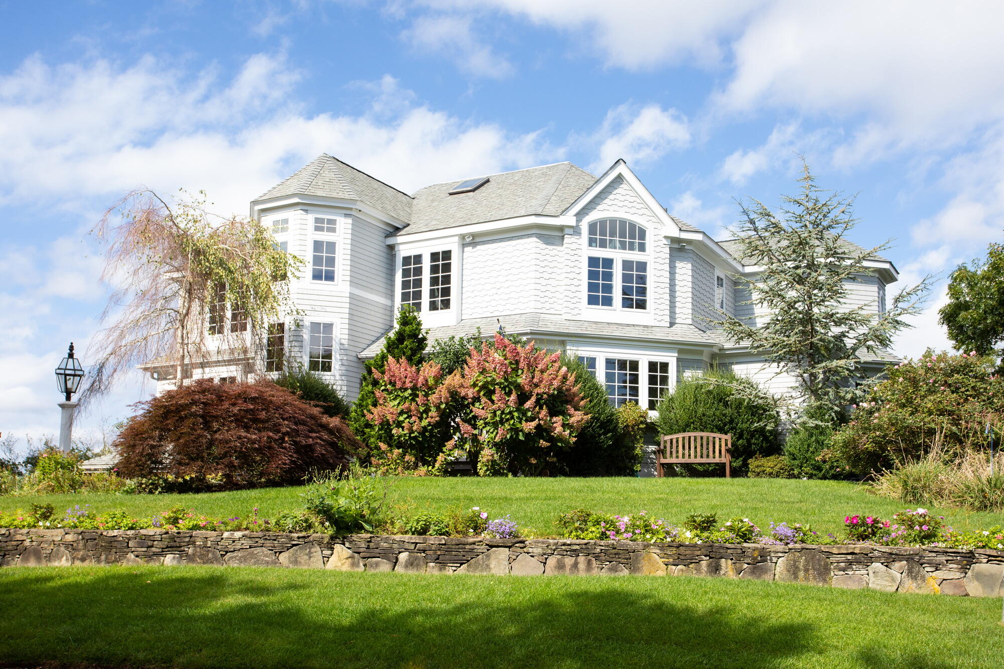 a front view of a house with a garden
