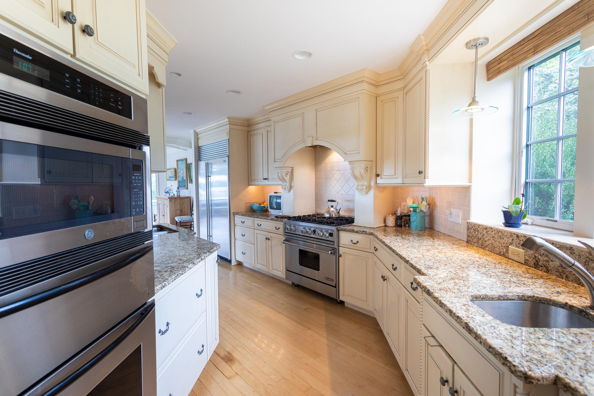157 Monomoscoy Road Mashpee, MA 02649 - Photo 12 of 43 a kitchen with granite countertop stainless steel appliances a stove sink and cabinets