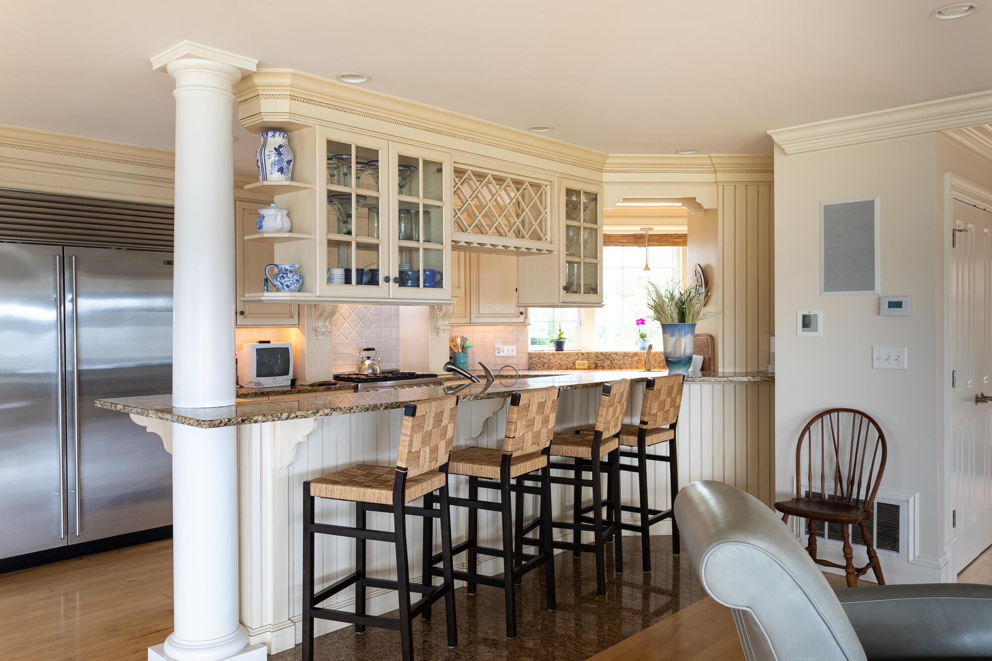157 Monomoscoy Road Mashpee, MA 02649 - Photo 13 of 43 a dining table with chairs and kitchen view