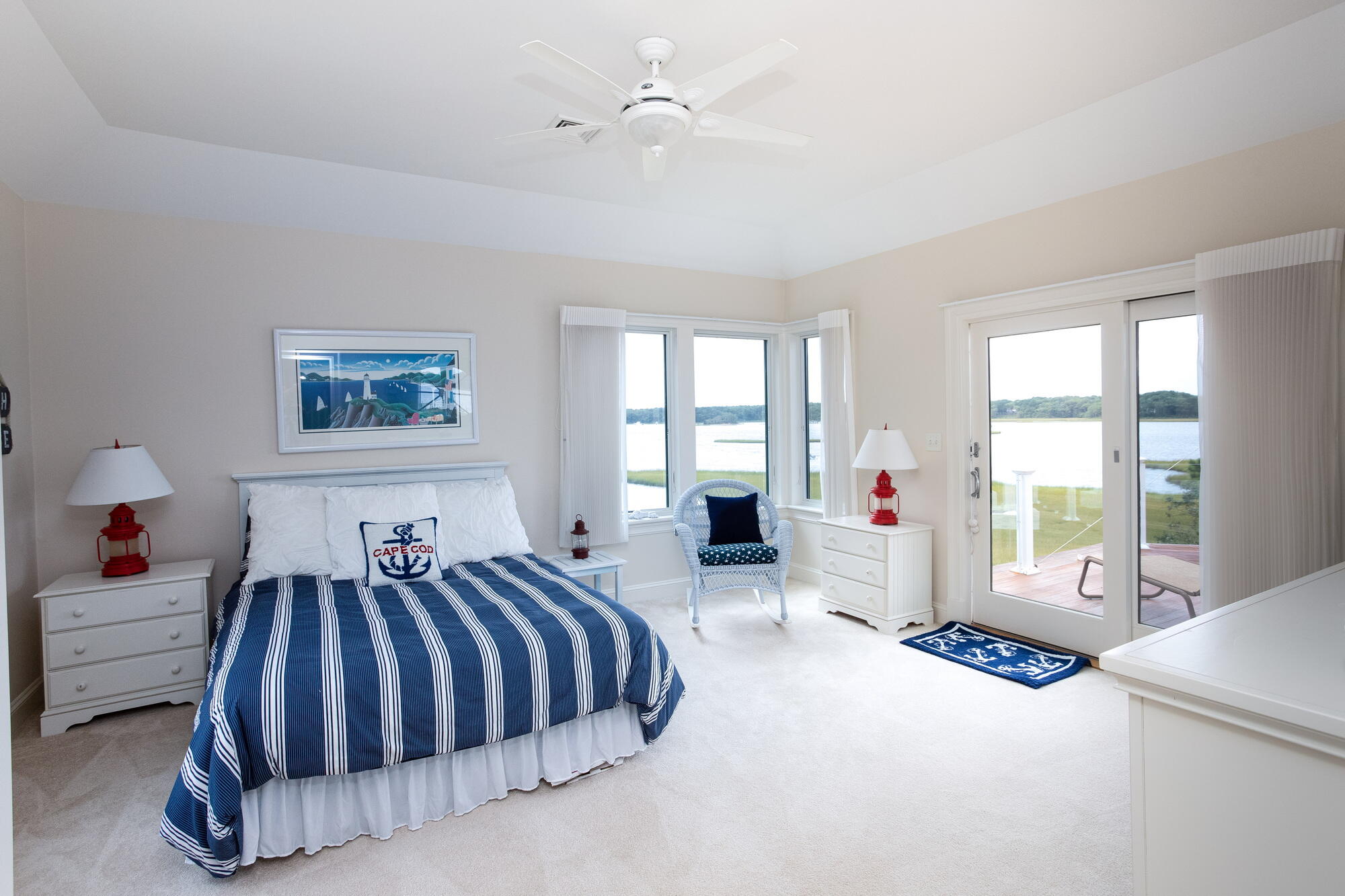 157 Monomoscoy Road Mashpee, MA 02649 - Photo 15 of 43 a spacious bedroom with a bed and glass door