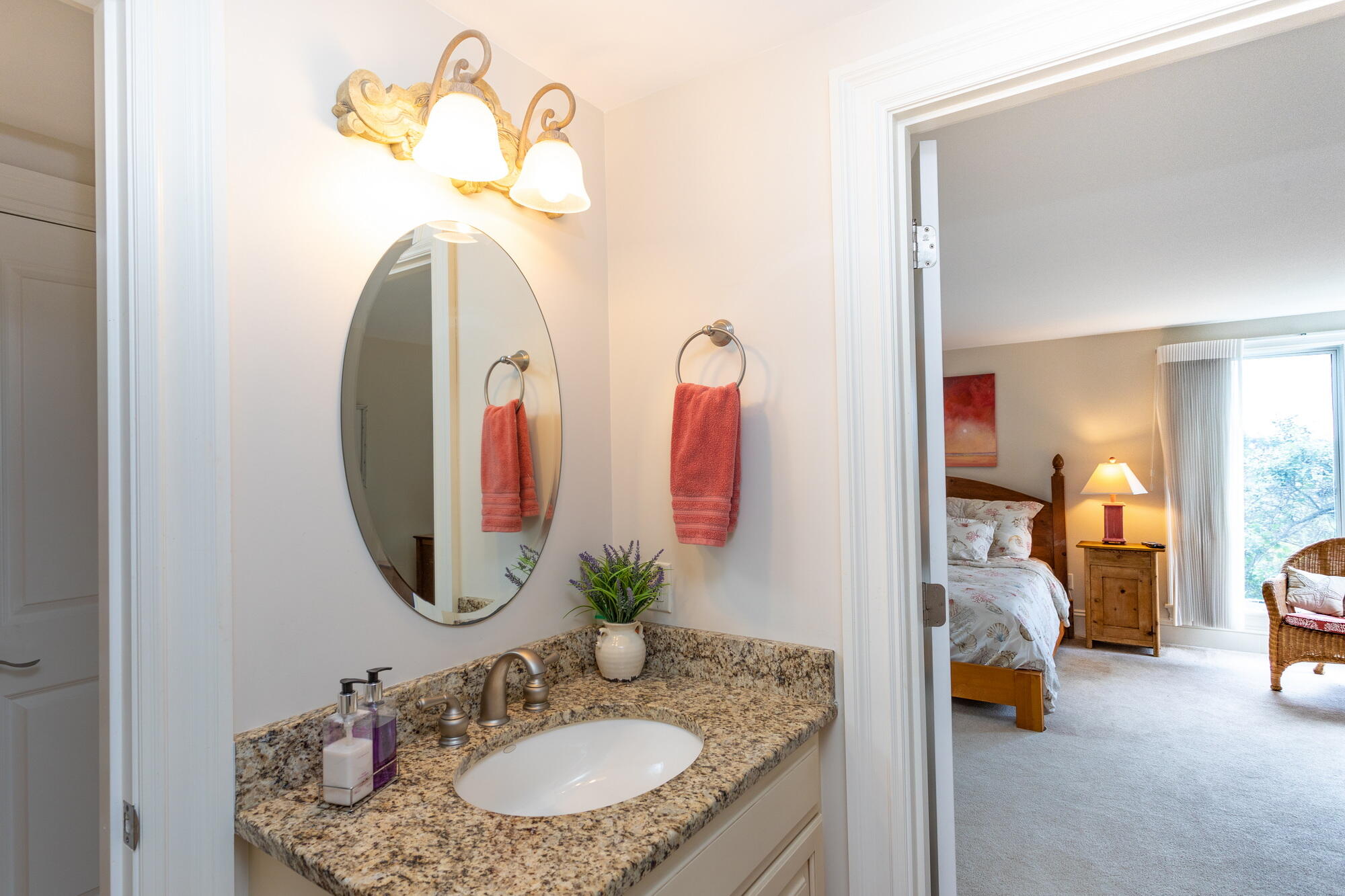 157 Monomoscoy Road Mashpee, MA 02649 - Photo 18 of 43 a en suite bathroom with a granite countertop sink and a mirror