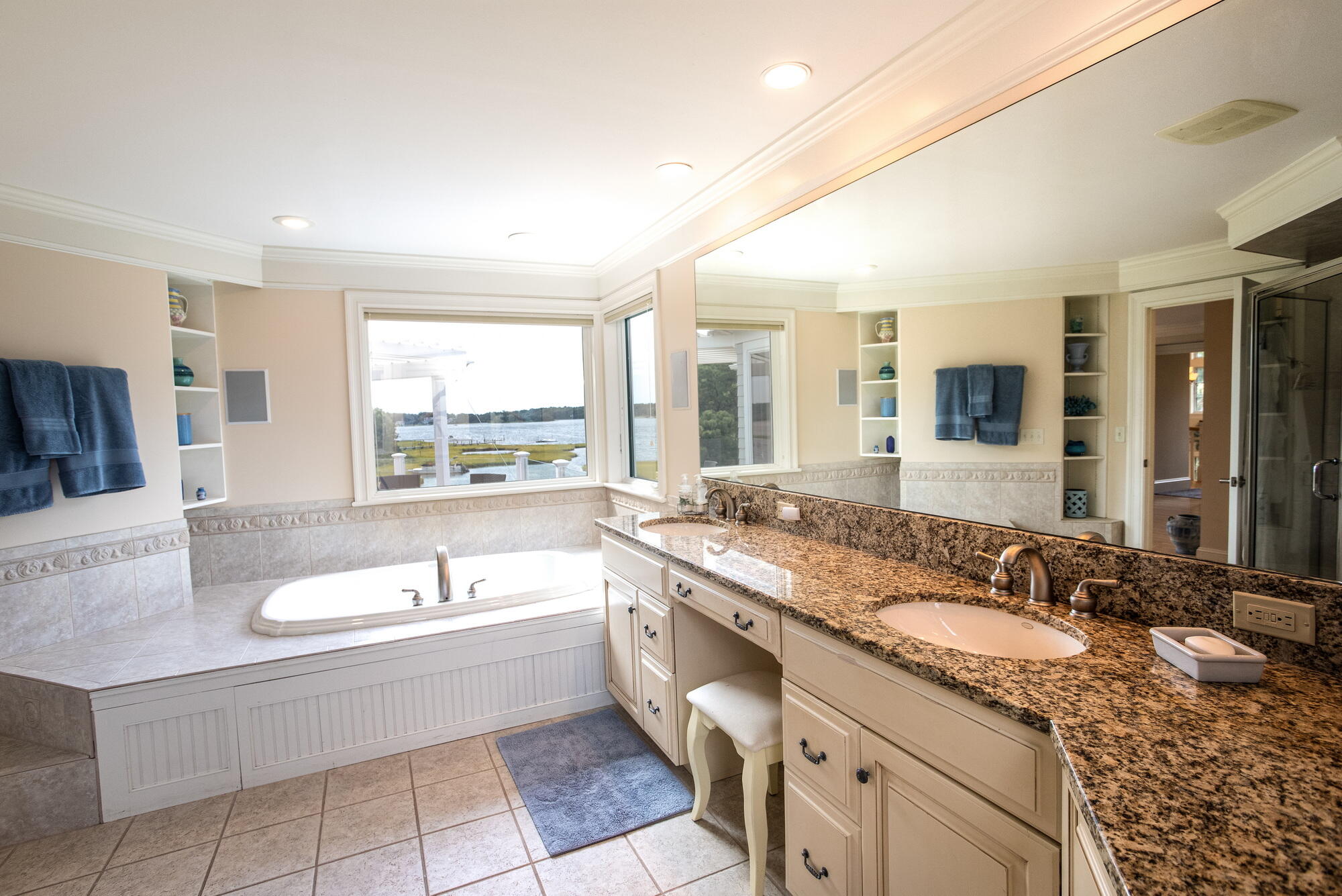 157 Monomoscoy Road Mashpee, MA 02649 - Photo 24 of 43 a bathroom with a granite countertop tub a double vanity sink a mirror and a bathtub