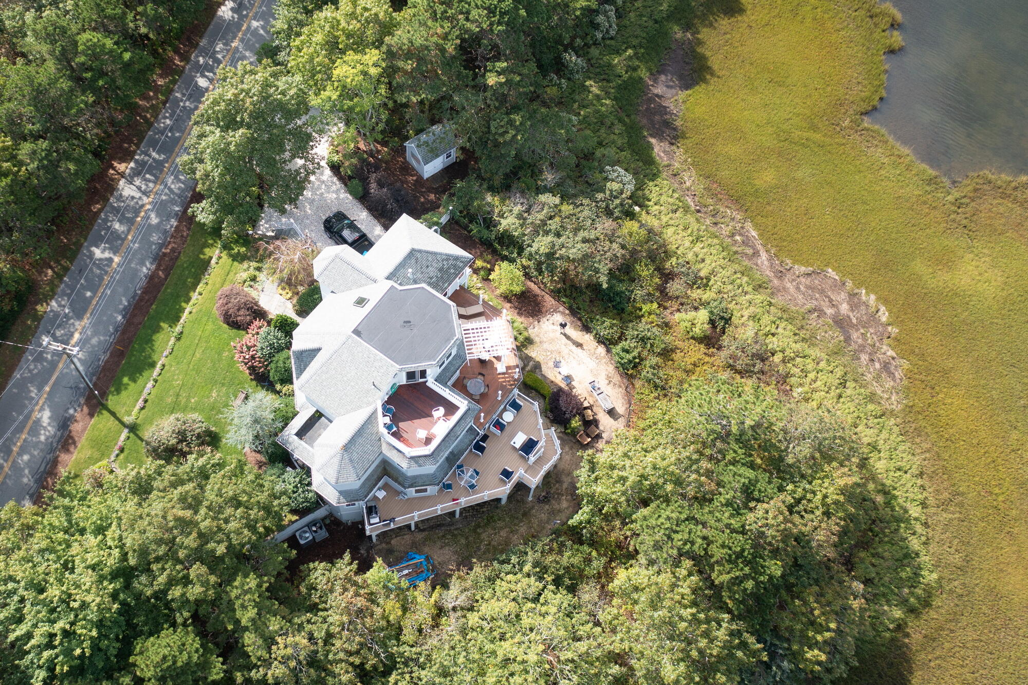 157 Monomoscoy Road Mashpee, MA 02649 - Photo 42 of 43 a aerial view of a house with a yard and lake view