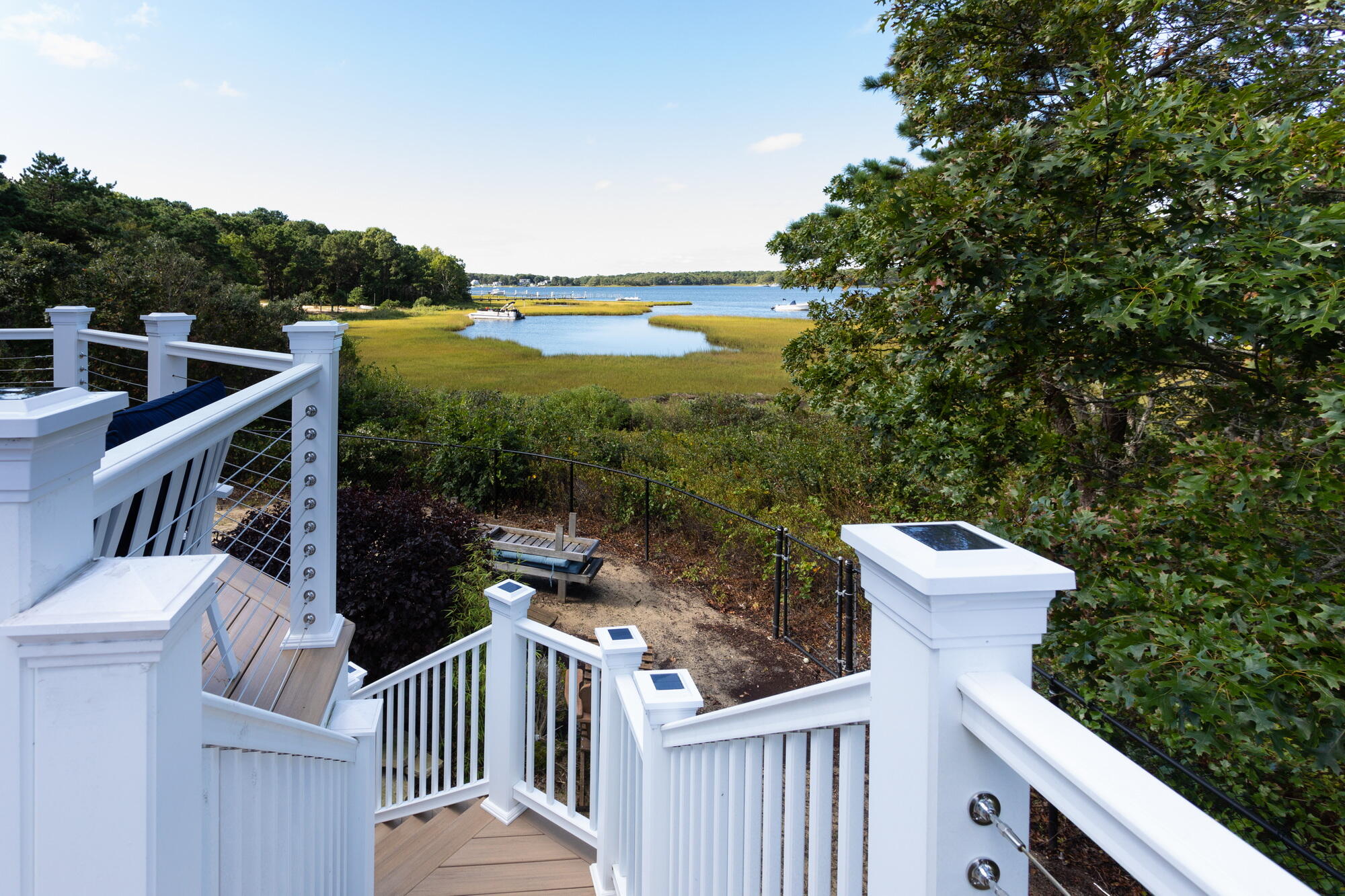 157 Monomoscoy Road Mashpee, MA 02649 - Photo 9 of 43 a view of a balcony with wooden floor and fence