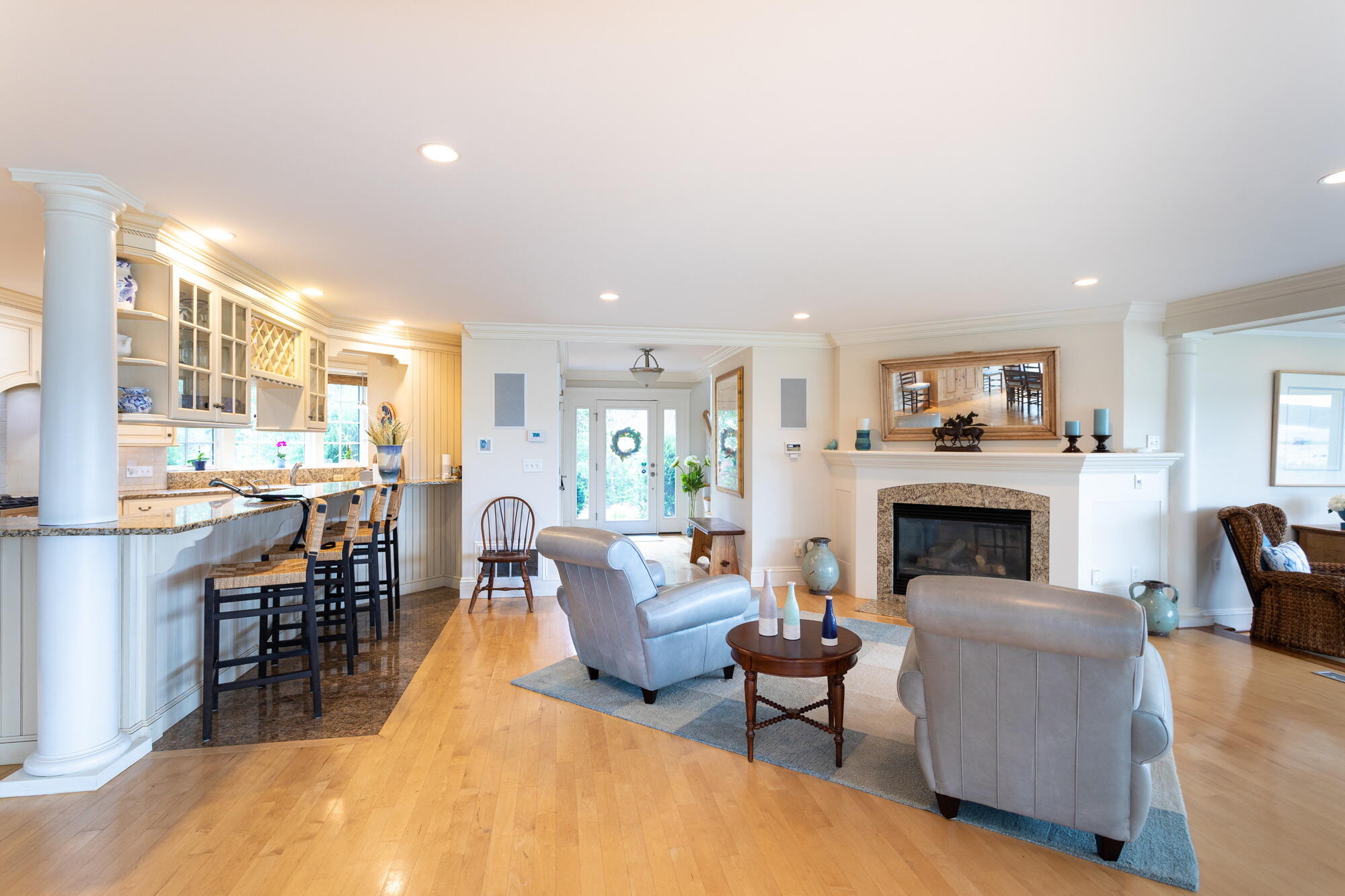 157 Monomoscoy Road Mashpee, MA 02649 - Photo 10 of 43 a living room with furniture a fireplace and a kitchen view